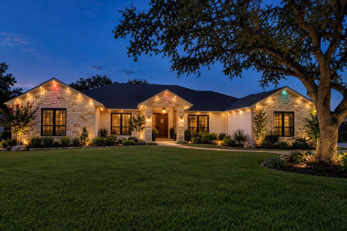 Texas ranch home at dusk with permanent LED lighting glowing under the roofline